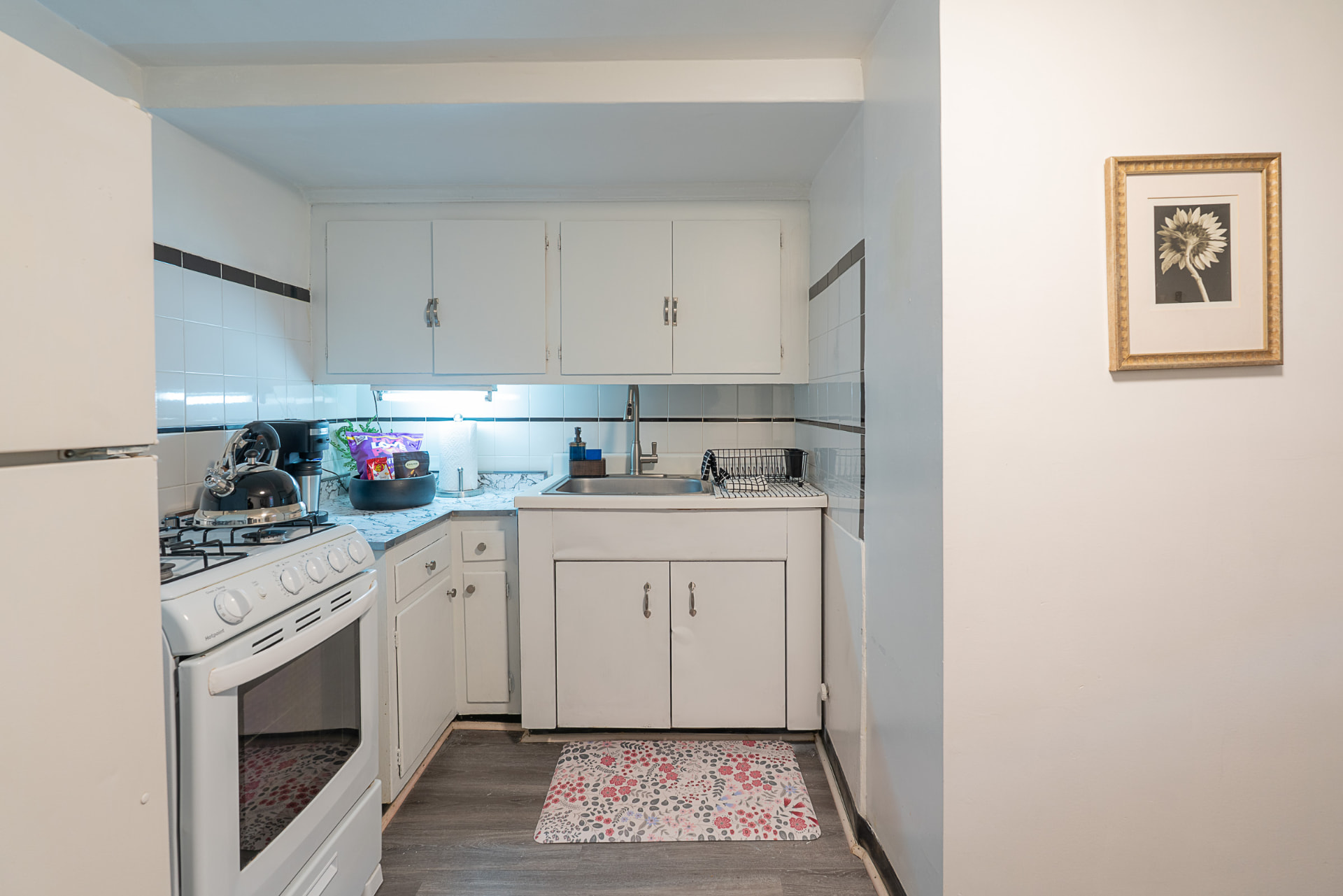 Full kitchen with essential kitchenware and a coffee maker